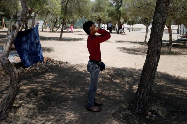 A migrant prays during the first day of Ramadan at a state-run camp for refugees and migrants in Schisto, near Athens, Greece June 6, 2016. REUTERS/Alkis Konstantinidis