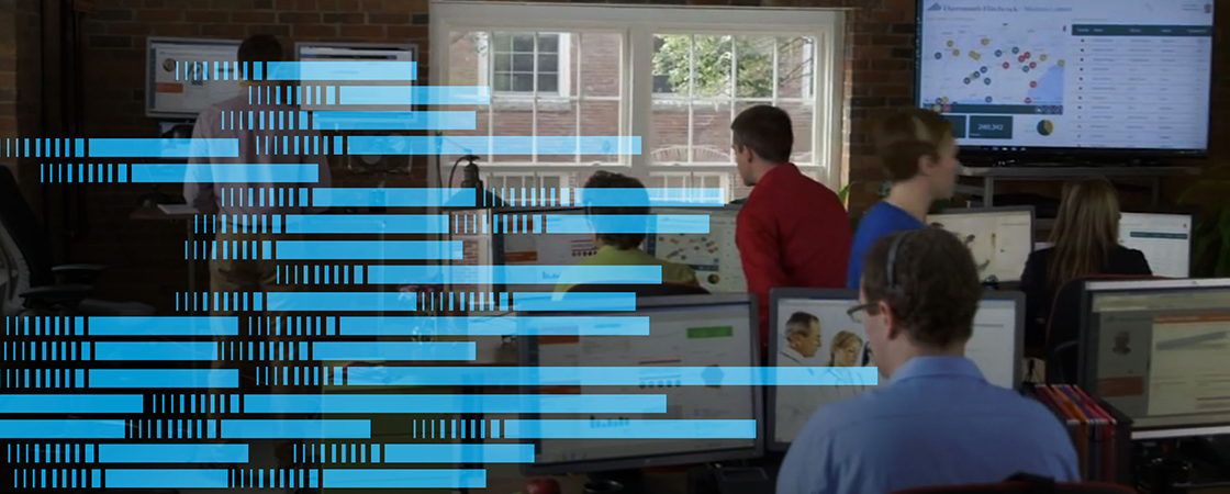 Photo of people in an open office environment.