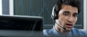 man-on-headset-in-front-of-computer