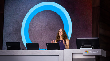 Woman presenting on stage