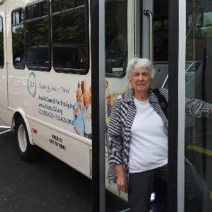 woman boards the JCA bus