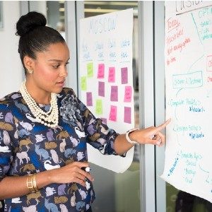 woman pointing to whtieboard
