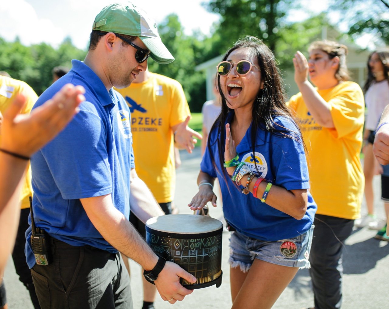 Camp staff playing drums and singing outside