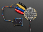 Monochrome 1.3" OLED module with Adafruit logos falling like snow