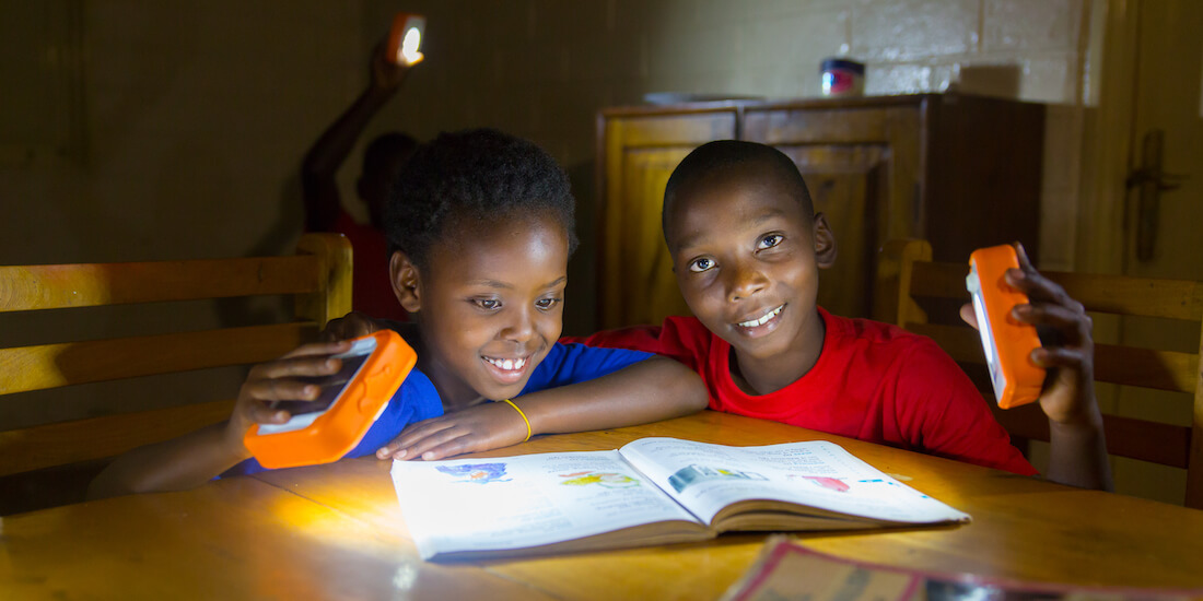 energy poverty solarbuddy two boys using the lights