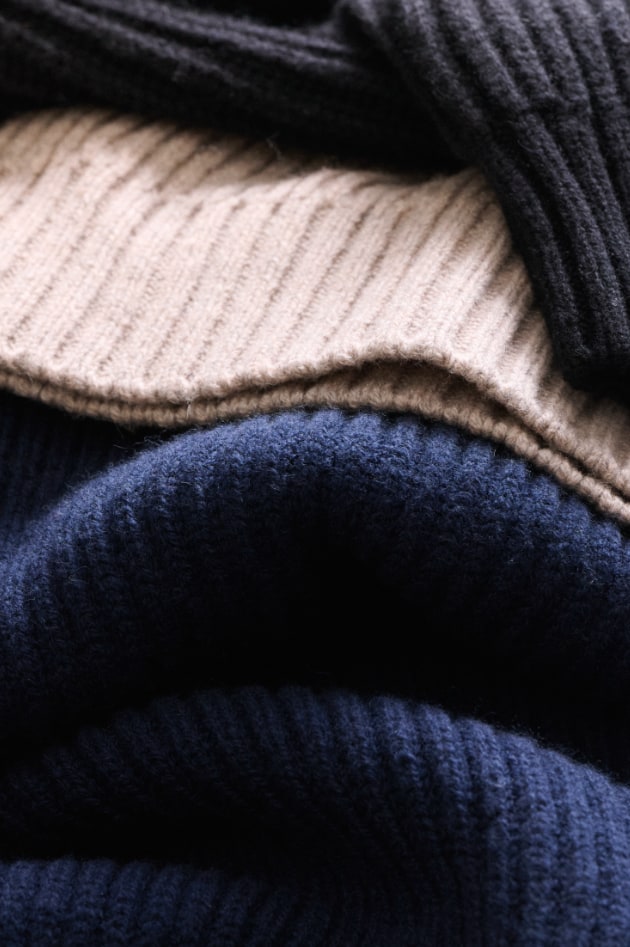Closeup of soft, textured sweaters and knitwear