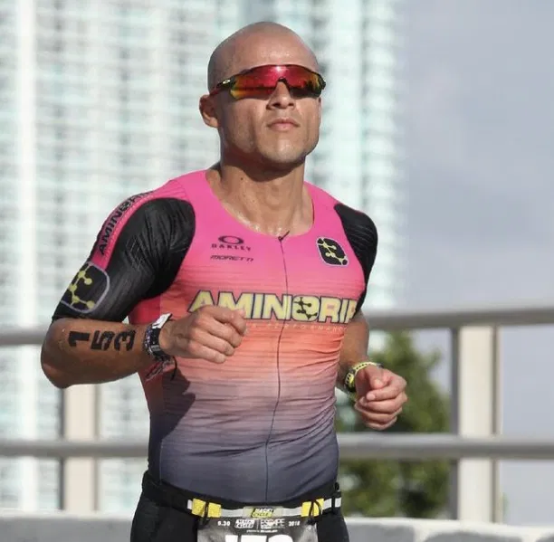 a runner wearing red sunglasses and running shirt.