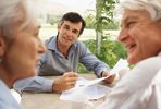 Photo of older couple receiving financial advice