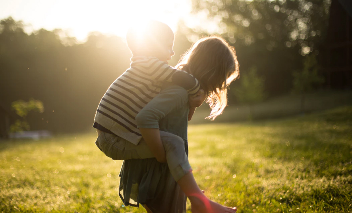 Children playing on a lawn.