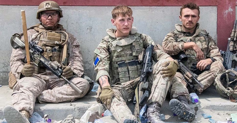British armed forces work with the U.S. military to evacuate eligible civilians and their families out of the country on August 21, 2021 in Kabul, Afghanistan.