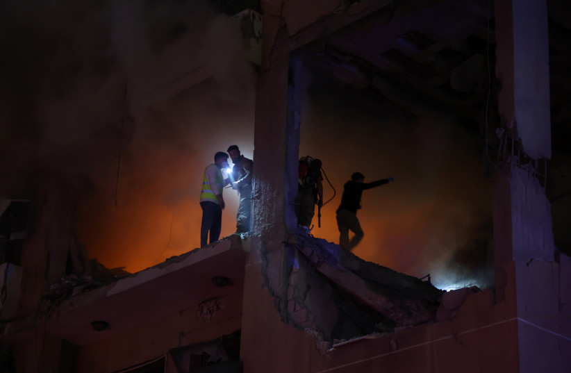  Members of civil defence stand at the site of an explosion, in what security sources say is an Israeli drone strike, in Beirut, Lebanon January 2, 2024 (credit: REUTERS/MOHAMED AZAKIR)