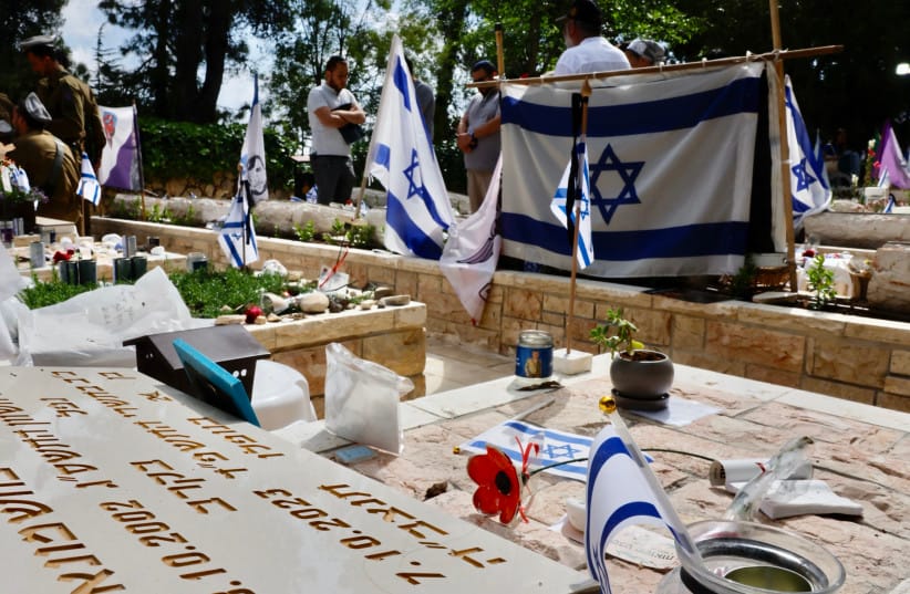 Bereaved Israelis seen at the Mount Herzl military cemetery, in Jerusalem, May 12, 2024