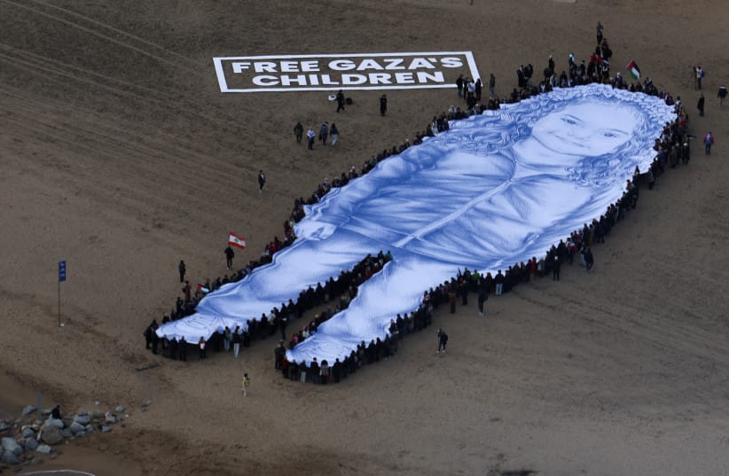 A giant portrait of 5-year-old Palestinian girl Hind Rajab who was killed in Gaza in 2024, is unfurled on Barceloneta Beach in the second anniversary of her death and after a film about her death received an Oscar nomination, in Barcelona, Spain January 29, 2026.