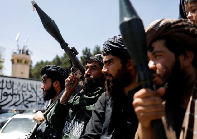  Taliban soldiers celebrate on the second anniversary of the fall of Kabul on a street near the US embassy in Kabul, Afghanistan, August 15, 2023. 