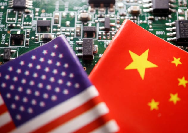  Flags of China and U.S. are displayed on a printed circuit board with semiconductor chips, in this illustration picture taken February 17, 2023.