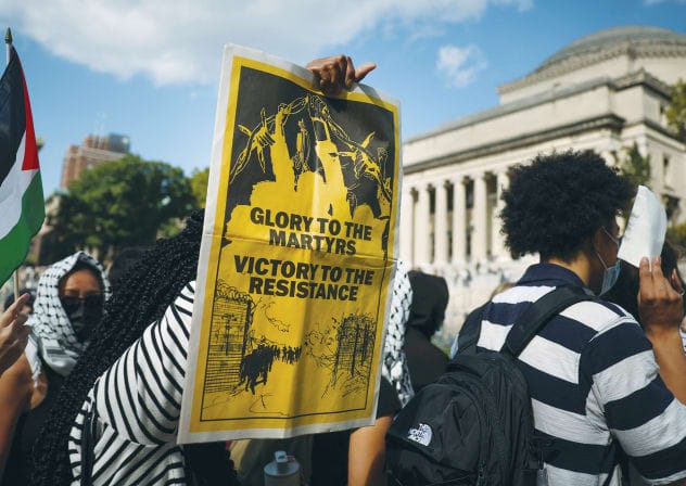  A PRO-PALESTINIAN demonstrator holds a sign that reads, ‘Glory to the martyrs, victory to the resistance,’ on Columbia University campus, on the first anniversary of the Hamas attack on Israel. 