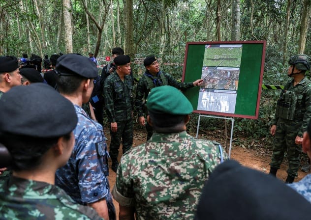 Thai military personnel explain the situation to delegates from the ASEAN Interim Observer Team (IOT), as they inspect the site of a recent landmine incident, in which Thai military said a Thai soldier stepped on a landmine on August 12 in Surin Province, Thailand, August 20, 2025.