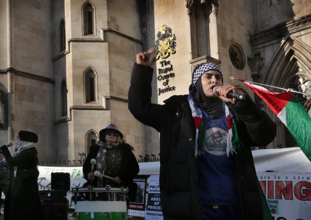 A protester leads the chants during the demonstration outside the Royal Courts of Justice as the Judicial Review starts on November 26, 2025 in London, United Kingdom