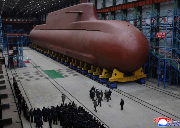 NORTH KOREAN leader Kim Jong Un visits the construction site of an 8,700-ton nuclear-powered submarine capable of launching surface-to-air missiles in this picture released by North Korea's official Korean Central News Agency on December 25, 2025.