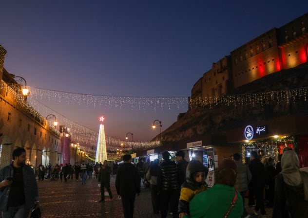 Iraqis visit a Christmas market set-up at the foot of the city's ancient Citadel in Arbil, the capital of Iraqi's northern autonomous Kurdish region, on Christman eve, December 24, 2025. 