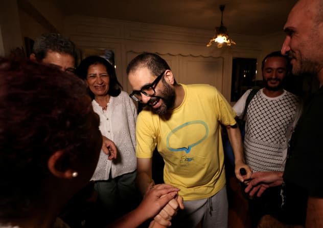 Prominent British-Egyptian activist Alaa Abd el-Fattah, who was released from prison after Egyptian President Abdel Fattah al-Sisi issued a presidential pardon for him, greets family and friends at their home in Giza, Egypt, September 23, 2025.