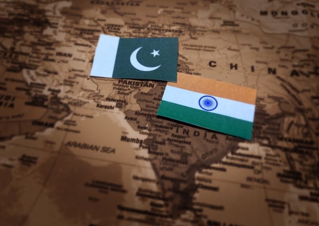 India and Pakistan flags with a map in the backdrop. Ilustrative.