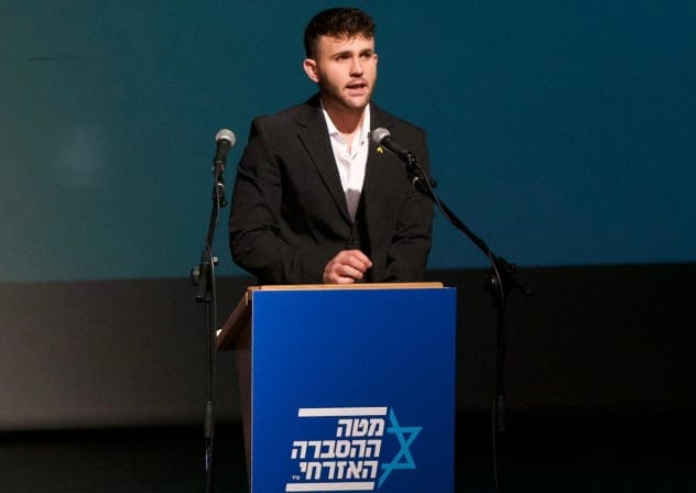 Civil Advocacy Center head Eliav Batito speaking at the Jerusalem Theatre.