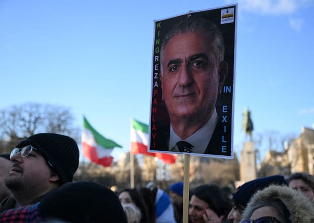 A PROTESTOR holds a placard of Iranian opposition leader and son of the last Shah of Iran, Reza Pahlavi, during a demonstration against the Iranian regime's crackdown on protests in central Paris, on January 4, 2026. 