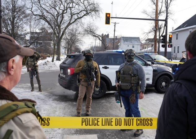 Members of US Immigration and Customs Enforcement (ICE) stand guard after a driver of a vehicle was shot in Minneapolis, Minnesota, US, January 7, 2026.