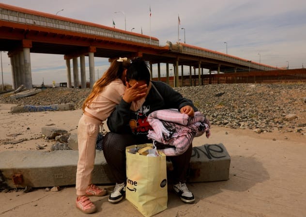 Griselda Hernandez, a Venezuelan migrant who crossed into the United States with her family in 2023 using the CBP One app and self-deported to Mexico in December 2025, is embraced by her daughter Valentina near the border in Ciudad Juarez, Mexico, January 22, 2026.