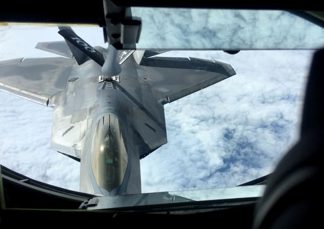 One of two US Air Force F-22 stealth fighter jets receives fuel mid-air from a KC-135 refueling plane over Norway en route to a joint training exercise with Norway's growing fleet of F-35 jets August 15, 2018. 