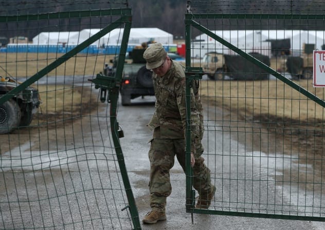 A US Army soldier from the 82nd Airborne Division closes the gate of an airbase, amid Russia's invasion of Ukraine, near Arlamow, Poland, April 5, 2022.