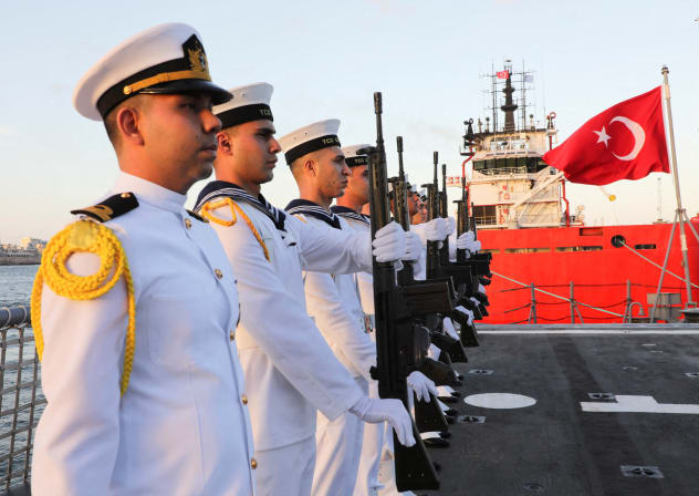 Turkish navy forces stand aboard the TCG Gaziantep (F-490), a Gabya-class (formerly Oliver Hazard Perry-class) guided-missile frigate operated by the Turkish Naval Forces, before the ceremony to launch the drilling vessel Cagri Bey, which is set to conduct Turkey's first deep-sea drilling operation 