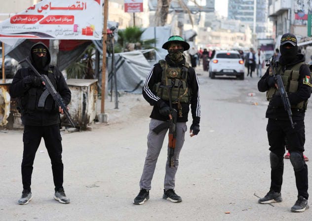 Terrorists from Hamas and Palestinian Islamic Jihad stand on a street during Eid al-Fitr in Gaza City, March 20, 2026.