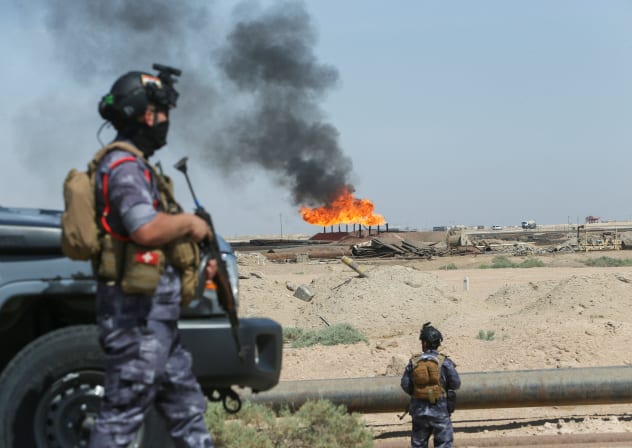 Gas flares burn at the Rumaila oil field during an armed patrol by Iraqi Energy Police in Basra, Iraq, June 8, 2026.