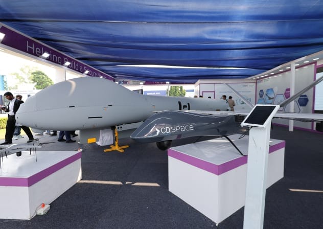 A view shows a model of Drishti 10(Starliner), a medium-altitude long-endurance unmanned aerial vehicle, and SkyStriker, tactical loitering munitions for covert and precise airstrikes, by Adani Defence and Aerospace at their stall during the drone exhibition at Bharat Drone Shakti 2023.