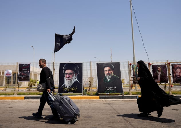 Iranian Shi'ite pilgrims walk along a road to enter Iraq through the Shalamcheh border crossing between Iran and Iraq to make their way to the holy city of Karbala to attend the Arbaeen pilgrimage, following US strikes on the Iranian side of the border crossing, in Basra, Iraq, July 23, 2026.
