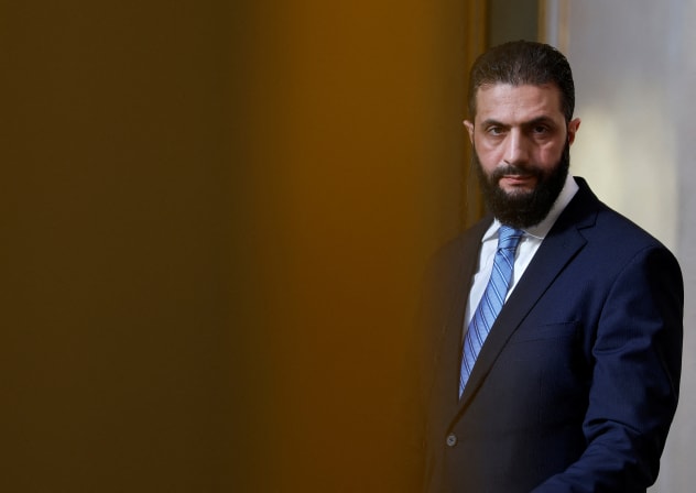 Syrian President Ahmed al-Sharaa listens to French President during a joint press conference after a meeting at the Elysee Palace in Paris, on May 7, 2025.
