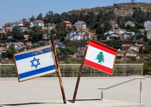 Representations of the Israeli and Lebanese flags at a memorial near the Israel-Lebanon border, after Israel and Lebanon signed a framework agreement following U.S.-mediated talks, as the town of Metula, Israel, appears in the distance, June 27, 2026.