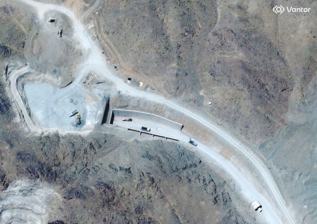 SATELLITE VIEW shows vehicles at an entrance to Pickaxe Mountain tunnels, near Natanz nuclear facility, in Iran, June 21.