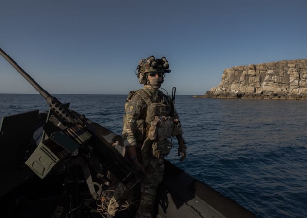 A member of "Timur's Special Forces Unit" of the Defence Intelligence of Ukraine waits on a military boat next to Snake Island, also known as Zmiinyi Island, located in the Black Sea, on August 14, 2025.