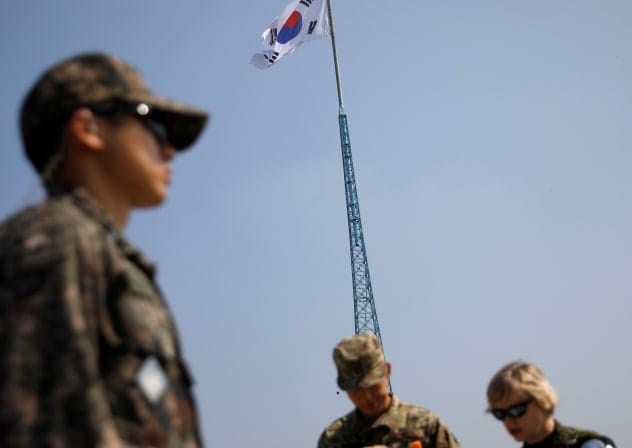 A South Korean flag flutters on the top of a 100-metre tower as soldiers stand guard at the Tae Sung freedom village near the Military Demarcation Line (MDL), inside the demilitarised zone separating the two Koreas, in Paju, South Korea, September 30, 2019. 