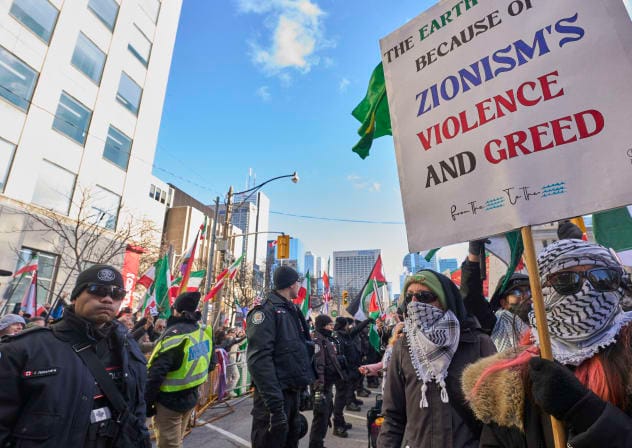 Police form a barrier between Al-Quds day protesters and pro-Israel counter protestors near the US Consulate in Toronto, Ontario, on March 14, 2026; illustrative