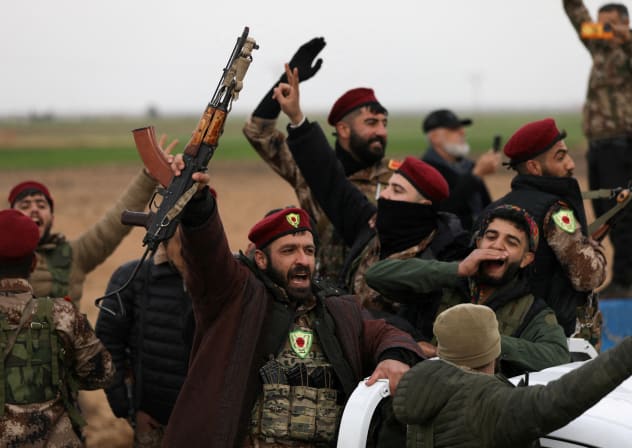 Members of Syrian Democratic Forces react after withdrawing from the front lines on the outskirts of the town of Tel Hamis following the agreement between the SDF and the Damascus government, which stipulates the withdrawal of the Syrian army and the SDF, in Qamishli, Syria, February 13, 2026. 