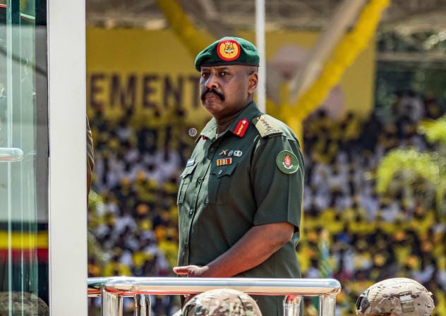 Muhoozi Kainerugaba, son of Yoweri Museveni and Uganda's Chief of Defence Forces, inspects a military parade from a vehicle during the inauguration ceremony of his father following his re-election as president at the Kololo Ceremonial Grounds in Kampala on May 12, 2026.