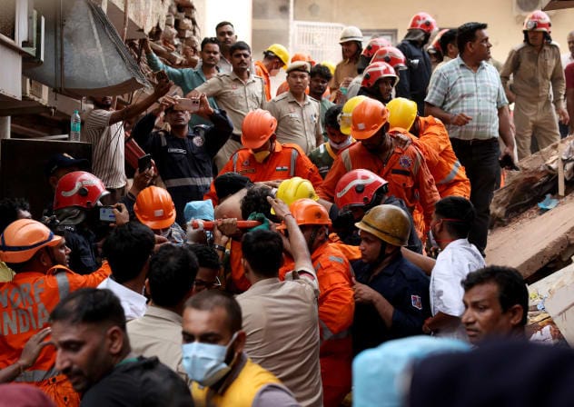 Members of rescue teams carry a victim after a building collapsed in New Delhi, India, September 6, 2026.
