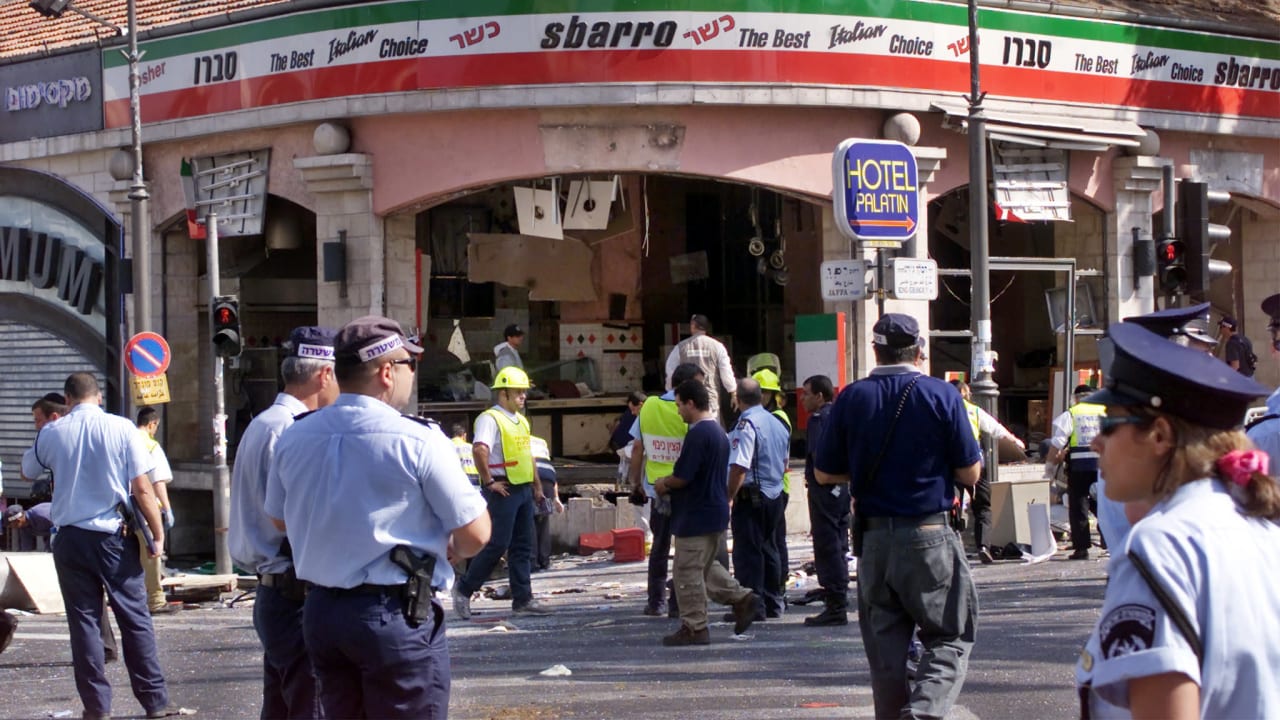 A gaping hole is left in the shop front of the Sbarro pizzeria after a suicide bombing, August 9, 2001