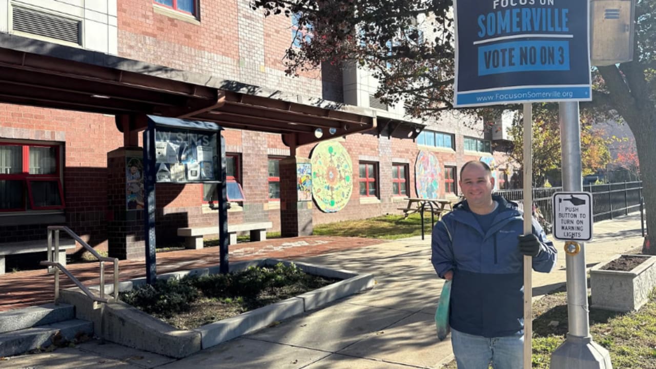 Josh Gensler-Steinberg holds a sign opposing an Israel boycott ballot initiative in Somerville, Massachusetts, in 2025.