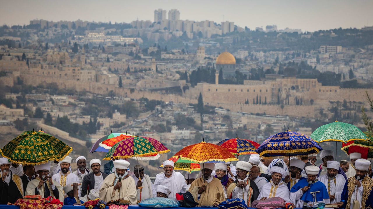 Ethiopian Jews take part in a prayer of the Sigd holiday on the Armon Hanatziv Promenade overlooking Jerusalem on November 28, 2024. 