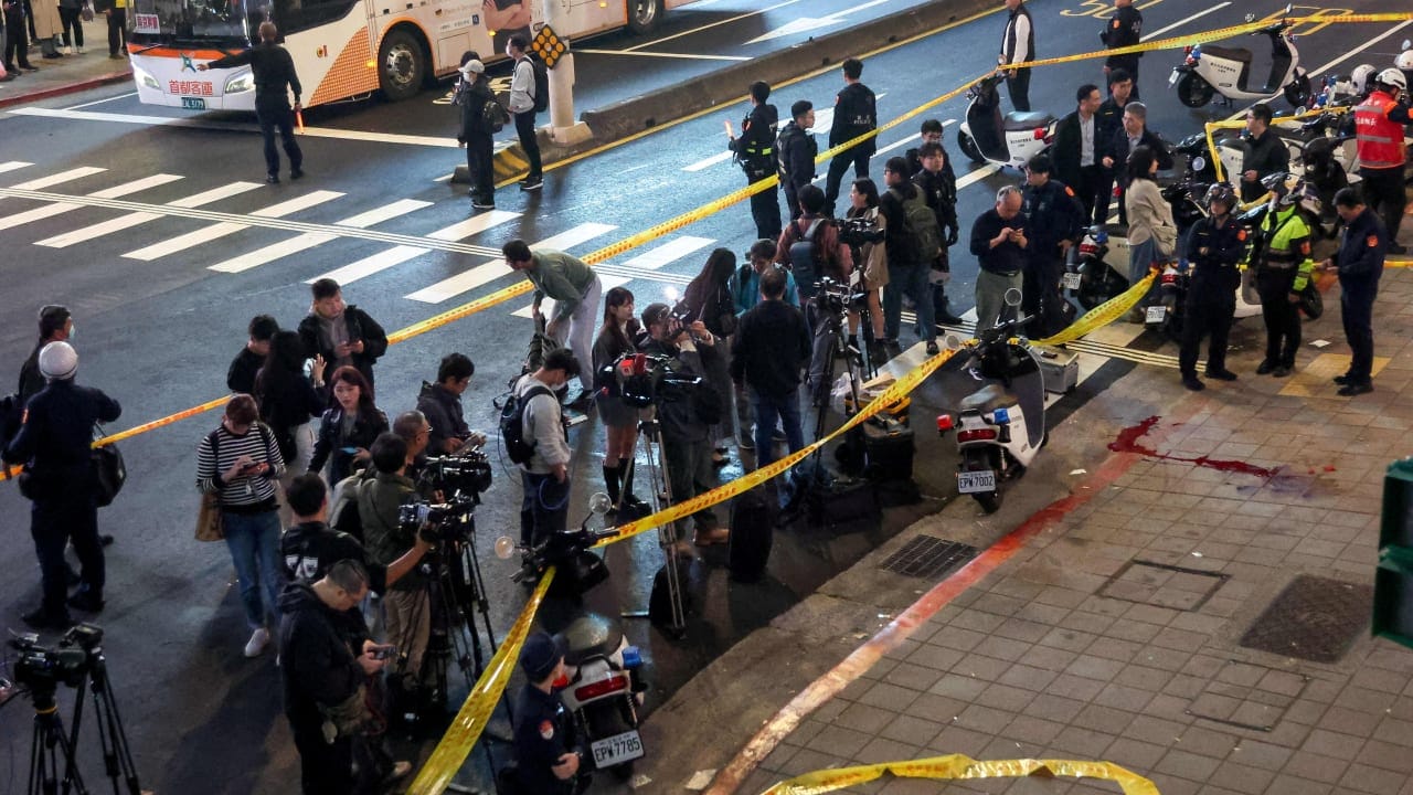 Media members stand outside Eslite Spectrum Nanxi store near Zhongshan station as the entrance of the building is cordoned off with yellow crime scene tape, following an incident in which several were injured after a person released smoke bombs and attacked bystanders, according to the government an